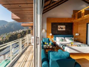 a hotel room with a bed and a balcony at Moustache Select Mcleodganj in Dharamshala