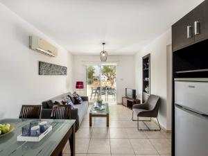 a living room with a couch and a table at Mythical Sands CB04 in Paralimni