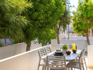 a table and chairs on a patio with trees at Mythical Sands CB04 in Paralimni +32 photos