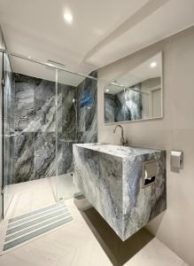 a bathroom with a large marble sink and a shower at FORESTE Haus 포레스테하우스 in Seoul +203 photos