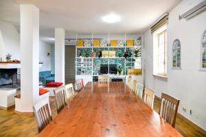 a dining room with a long table and chairs at Mary Jungle in Porto SantʼElpidio