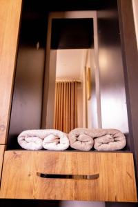 two towels sitting on a counter in front of a mirror at EKay's Space Najjera1 in Namugongo