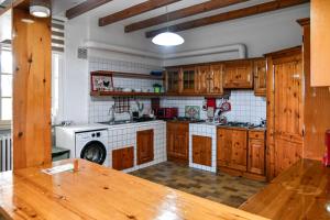 a kitchen with wooden cabinets and a wooden table at Mary Jungle in Porto SantʼElpidio