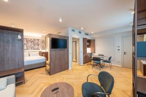 a hotel room with a bed and a table and chairs at Neo Hotel in Bresso