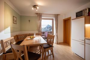 a kitchen and dining room with a table and chairs at Bauernhof Grafenhof in Ebbs