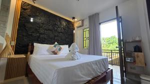 a bedroom with a bed with a towel on it at SilverLeaf in El Nido