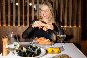 a woman sitting at a table with a plate of food at The Westin Warsaw in Warsaw +78 photos