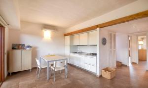 a kitchen and dining room with a table and chairs at Appartamenti sul mare in Santa Marinella