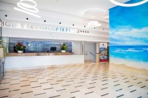 a lobby of a hotel with a beach mural at Hotel Servigroup Trinimar in Benicàssim +35 photos