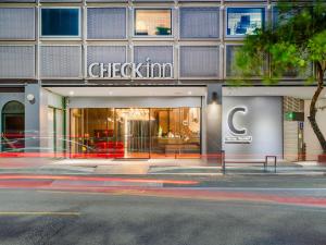 a store front of a building on a city street at CHECK inn Taichung Liming in Taichung