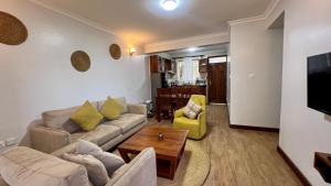 a living room with a couch and a table at Iwandaa Apartments in Nkoanrua