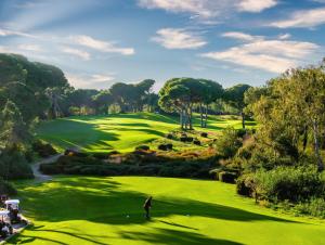 a man standing on a lush green golf course at Azure Villas By Cornelia in Belek