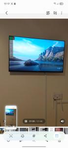 a flat screen tv hanging on a wall at Lins Haven in Kilifi