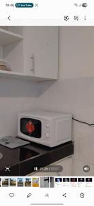 a microwave oven sitting on top of a kitchen counter at Lins Haven in Kilifi +5 photos