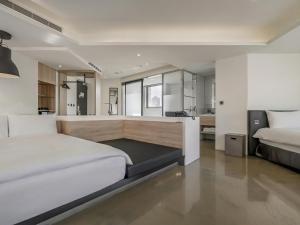 a bedroom with two beds and a desk in it at CHECK inn Taichung Liming in Taichung +113 photos