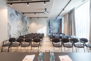 a conference room with a row of chairs and tables at Neo Hotel in Bresso +82 photos