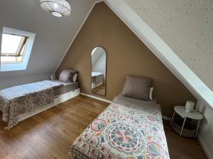a attic bedroom with a bed and a mirror at LMB stays in Recklinghausen