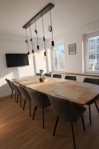 a dining room with a wooden table and chairs at LMB stays in Recklinghausen