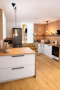 a kitchen with white cabinets and a black refrigerator at LMB stays in Recklinghausen +14 photos