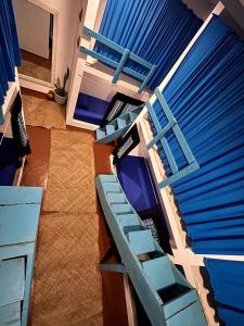 a bedroom with two bunk beds with blue furniture at Hostel by Sri villa polwatta in Weligama