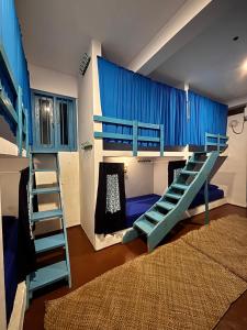 a bedroom with a bunk bed and a bunk ladder at Hostel by Sri villa polwatta in Weligama +11 photos