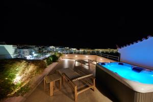 a hot tub on the roof of a building at KALLINO Island Suites in Ermoupoli