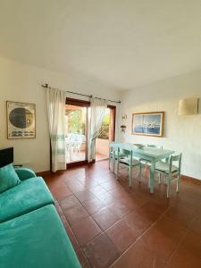 a living room with a table and a couch at Appartamenti sul mare in Santa Marinella