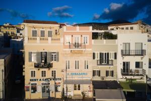 a group of tall buildings in a city at KALLINO Island Suites in Ermoupoli