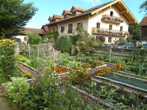 a garden in front of a house at Sailerhof Gramminger in Taching am See