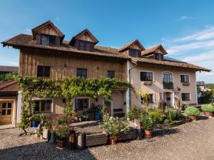 a house with a bunch of plants in front of it at Sailerhof Gramminger in Taching am See