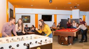 a group of people playing a game of snooker at Erlebnishotel Kärnten-Mölltal 3 Stern Superior in Obervellach +36 photos