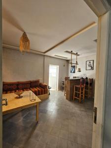 a living room with a couch and a table at summer house berber in Tamraght Ouzdar