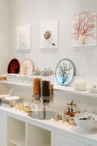 a white shelf filled with bowls and plates with food at Riviera Hotel in Senigallia
