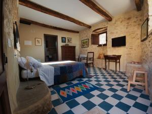 a bedroom with a bed and a checkered floor at B&B Manca1Fiorino in Spoleto