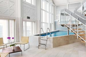 a large room with a swimming pool and a staircase at Scandic Star Sollentuna in Sollentuna