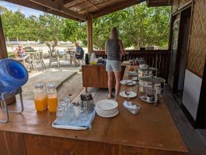 a woman standing on a table with food and drinks at Banana Beach Club in Moalboal