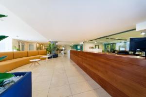 a lobby with a couch and a television in a building at Morasol Suites in Puerto Rico de Gran Canaria +66 photos
