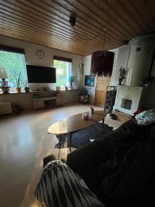 a living room with a couch and a table at Kråksjöviken in Västervik