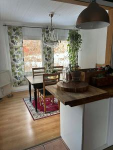 a kitchen with a table and a dining room at Kråksjöviken in Västervik