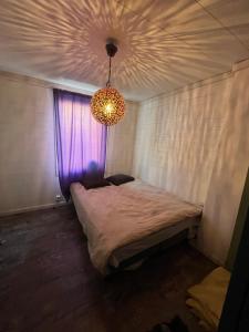 a bedroom with a bed with a purple window at Kråksjöviken in Västervik