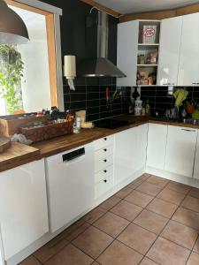 a kitchen with white cabinets and a counter top at Kråksjöviken in Västervik +4 photos