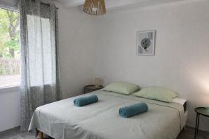 a bedroom with a bed with two pillows on it at Gite du Lac T4 in Vieux-Boucau-les-Bains