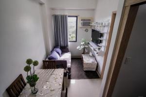 a living room with a table and a couch at R and K staycation in Manila