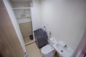 a small bathroom with a toilet and a sink at R and K staycation in Manila +7 photos
