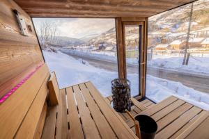 a room with a bench and a large window at Hillside Chalet Kreischberg in Sankt Lorenzen ob Murau