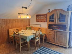 a dining room with a table and chairs and a kitchen at Bauernhaus Jocher in Krün