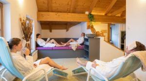 a group of people sitting in chairs in a living room at Erlebnishotel Kärnten-Mölltal 3 Stern Superior in Obervellach