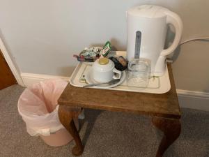 a table with a coffee maker on top of it at Beachy Rise in Eastbourne +14 photos