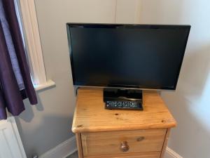 a television sitting on top of a wooden table at Beachy Rise in Eastbourne