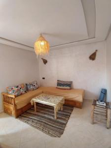 a living room with a bed and a table at summer house berber in Tamraght Ouzdar